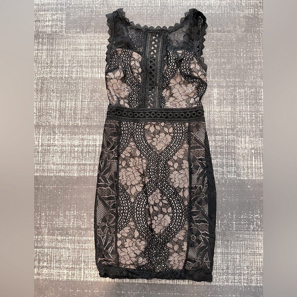 Black lace body-con mini dress, front slit detail.